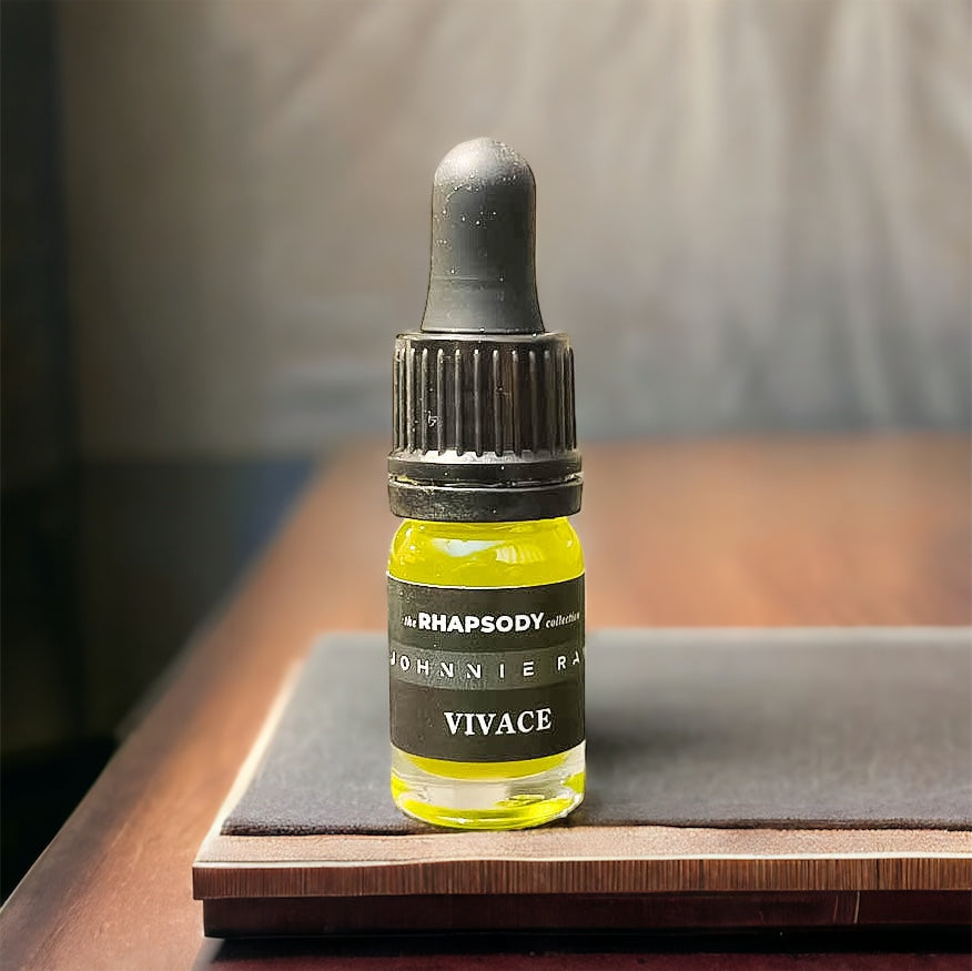 5mL bottle of The Rhapsody Collection Vivace Signature Blend Beard Oil from Johnnie Ray sitting on a wood table