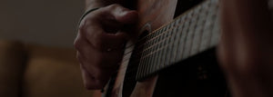 Close up view of someone playing guitar