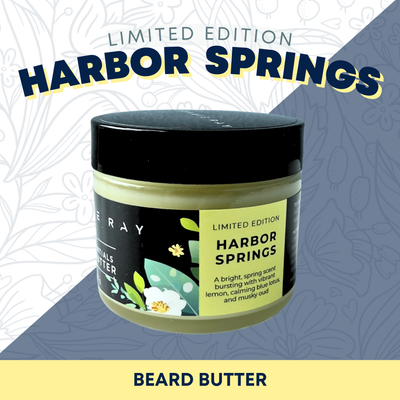 Jar of Johnnie Ray Beard Butter in Harbor Springs scent with a black label with yellow and green floral accents