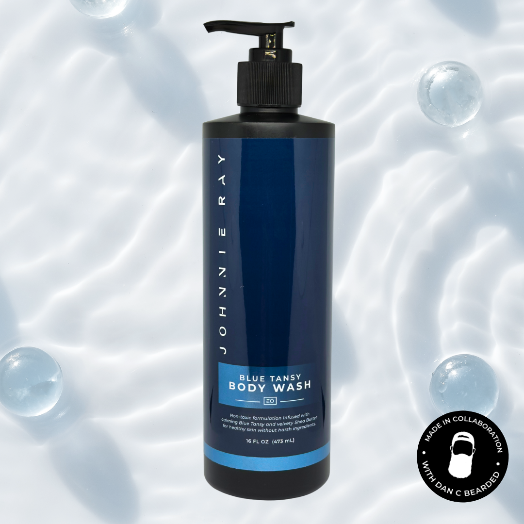 Johnnie Ray Blue Tansy Body Wash bottle on a background with bubbles