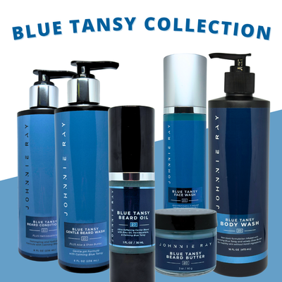 Collection of Johnnie Ray Blue Tansy grooming products on a gradient background