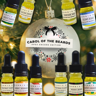 Collection of beard oil bottles with a Christmas ornament and tree in the background, featuring 'Carol of the Beards' brand.