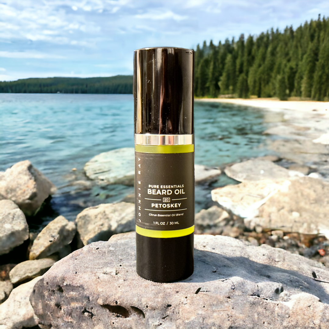 Bottle of Johnnie Ray Petoskey Beard Oil on rock in front of a lake