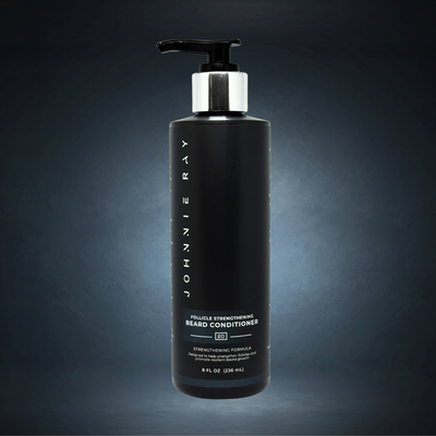 Black bottle of Johnnie Ray beard conditioner on a dark background