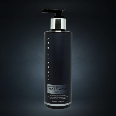 Black bottle of Johnnie Ray beard growth stimulator wash on a dark background