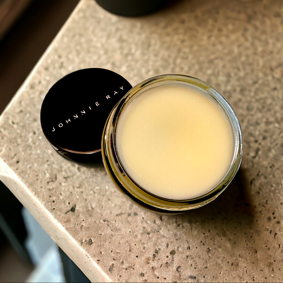Jar of Johnnie Ray Petoskey Beard Butter with lid open on concrete counter