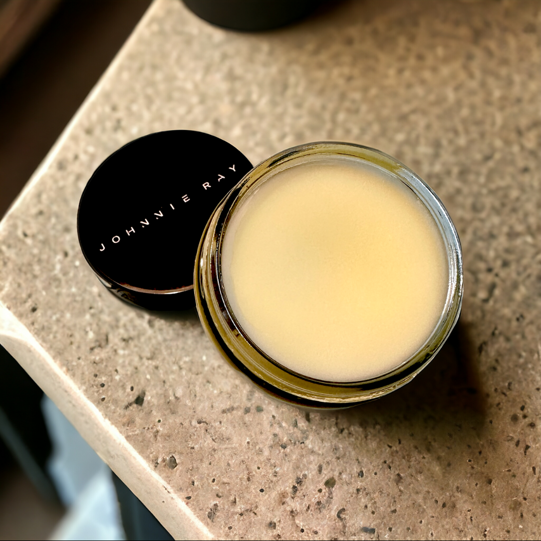 Jar of Johnnie Ray Sleeping Bear Beard Butter with lid open on concrete counter