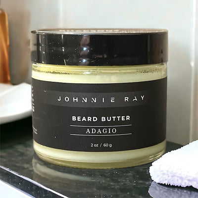 Johnnie Ray Adagio Beard Butter from The Rhapsody Collection sitting on a black granite countertop